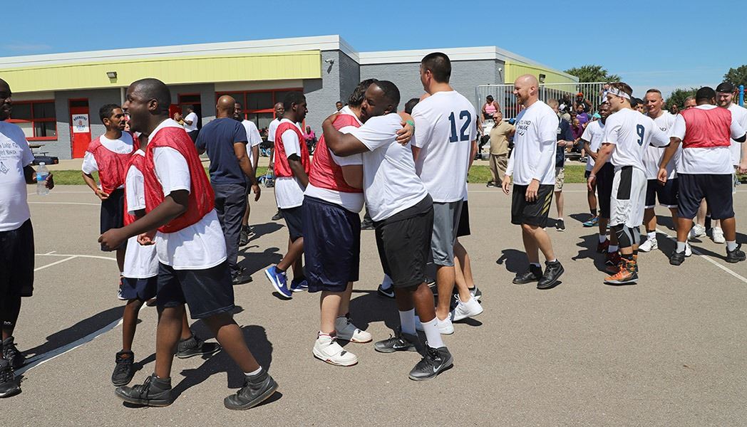 Police officers playing basketball with the community